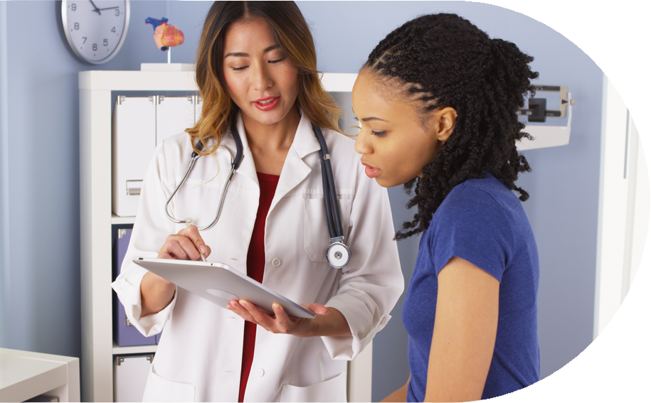 Doctor showing patient paper on a clipboard.